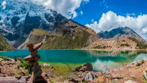 Wide shot of the lagoon with its characteristic turquoise color and the Humantay snow-capped mountain behind it.