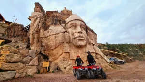 ATV riders exploring the Abode of the Gods in Cusco, surrounded by stone sculptures and Andean landscapes during an adventure tour.