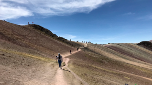 The Palcoyo Rainbow Mountain hike includes gentle trails, panoramic viewpoints, and vibrant striped hills perfect for travelers seeking a less crowded experience.