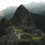 Trekker arriving at Machu Picchu after completing the Short Inca Trail, enjoying views of the citadel, terraces, and surrounding mountains.